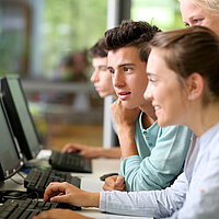 Jugendliche schauen in Computermonitore